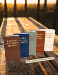 All five RanchWise guidebooks fanned out on a wooden ranch table