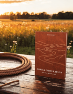 Core & Circulation guidebook by RanchWise beside a leather rope on a ranch table