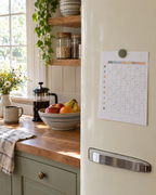 Printed weekly habit tracker on a farmhouse refrigerator